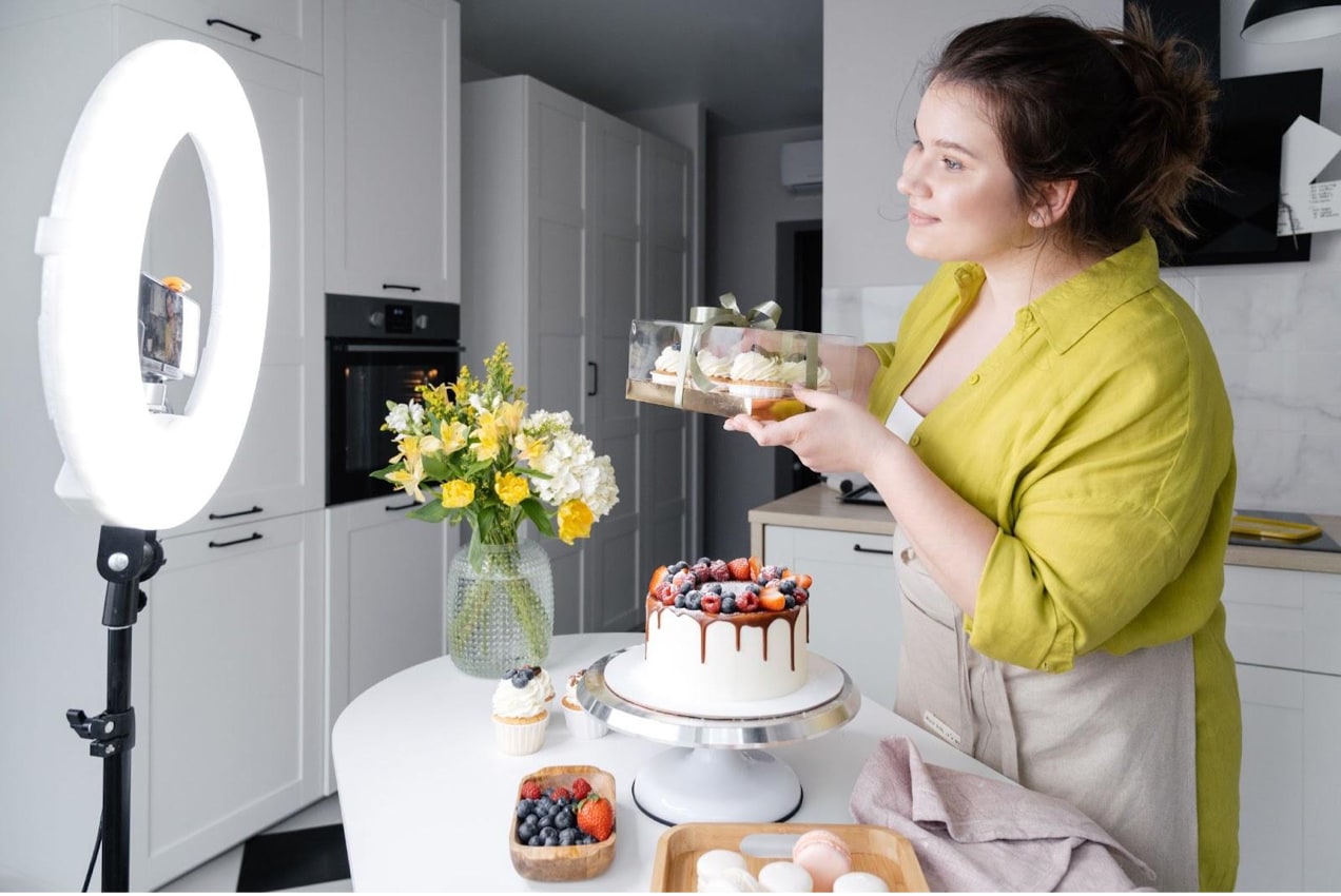 woman recording a baking video in front of a camera
