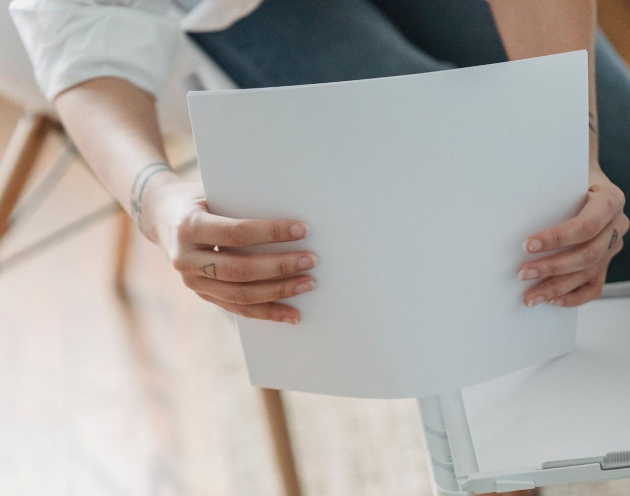 woman putting together a stack of papers