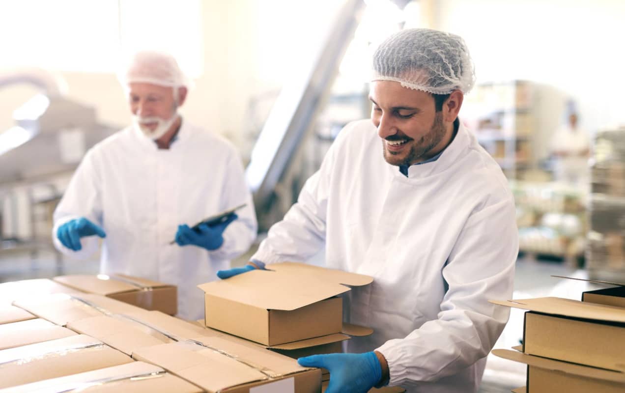 two men packaging food products