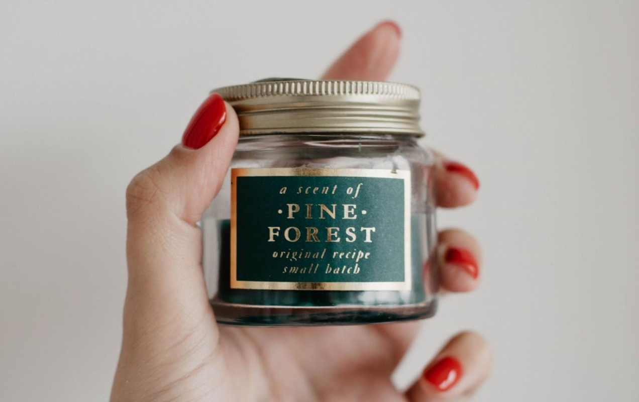 pine forest candle held in a hand