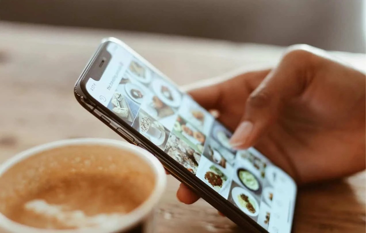 someone looking at Instagram at a coffee shop